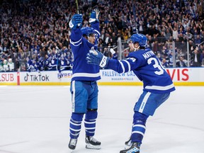 Toronto Maple Leafs centre Auston Matthews (right) celebrates with teammate Nick Robertson after setting Robertson up for an overtime winner against the Dallas Stars on Oct. 20.
