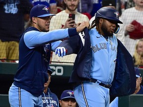 Toronto Blue Jays first baseman Vladimir Guerrero Jr. receives the blue jacket from pitcher Jose Berrios after hitting a solo home run against the St. Louis Cardinals during the sixth inning at Busch Stadium. (Jeff Curry-USA TODAY Sports)