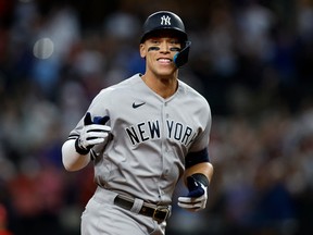 New York Yankees' Aaron Judge rounds the bases after hitting home run number sixty-two to break the American League home run record in the first inning against the Texas Rangers at Globe Life Field on Tuesday, Oct. 5, 2022.