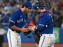 In this photo taken on Oct. 2, 2022, Toronto Blue Jays pitcher Jordan Romano and catcher Danny Jansen celebrate the win against the Boston Red Sox at Rogers Centre.