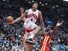 Apr 5, 2022; Toronto, Ontario, CAN; Toronto Raptors forward Scottie Barnes (4) controls the ball as Atlanta Hawks center Clint Capela (15) tries to defend during the fourth quarter at Scotiabank Arena.