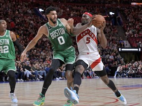 Oct 14, 2022; Montreal, Quebec, CAN; Toronto Raptors forward Precious Achiuwa (5) drives to the net and Boston Celtics forward Jayson Tatum (0) defends during the second quarter at the Bell Centre.