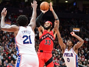 Oct 26, 2022; Toronto, Ontario, CAN; Toronto Raptors guard Gary Trent Jr. (33) shoots the ball over Philadelphia 76ers center Joel Embiid (21) and guard Tyrese Maxey (0) in the second half at Scotiabank Arena.