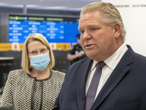 Ontario Premier Doug Ford and Solicitor General Sylvia Jones answer questions after touring the COVID-19 testing centre in Terminal 3 at Pearson Airport in Toronto on February 3, 2021.