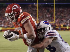 Kansas City Chiefs tight end Travis Kelce (87) catches an 8-yard touchdown pass over Buffalo Bills outside linebacker Matt Milano (58) during overtime in an NFL divisional round playoff football game, Sunday, Jan. 23, 2022, in Kansas City, Mo. The Chiefs won 42-36.