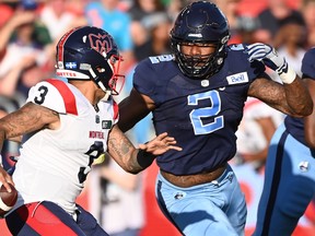 Alouettes quarterback Vernon Adams Jr.  scrambles before getting sacked by Argonauts' Shawn Oakman during first half CFL football action in Toronto Thursday, June 16, 2022.