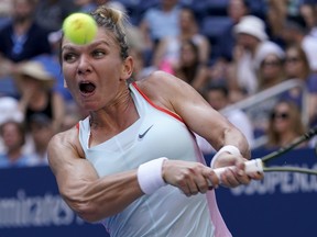 Simona Halep, of Romania, returns a shot to Daria Snigur, of Ukraine, during the first round of the US Open tennis championships, Monday, Aug. 29, 2022, in New York.