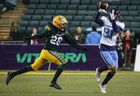 Argonauts' Tommy Nield catches a pass as Edmonton Elks' Jamie Harry looks on during second half CFL football action in Edmonton, Saturday, Oct. 15, 2022.