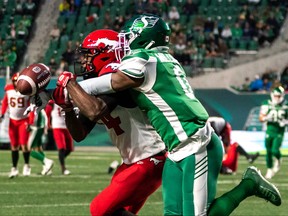 Saskatchewan Roughriders defensive back Rolan Milligan (0) knocks away an intended pass for Calgary Stampeders wide receiver Shawn Bane Jr. (14) during the first half of CFL football action in Regina on Saturday, October 22, 2022.
