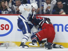 Leafs' Morgan Rielly goes after Jets' Josh Morrissey during the second period on Saturday night in Winnipeg.