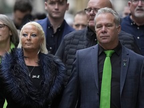 The father of Harry Dunn, Tim Dunn, right, and stepmother, Tracey Dunn, arrive at the Old Bailey Central Criminal Court in London, Thursday, Oct. 20, 2022.