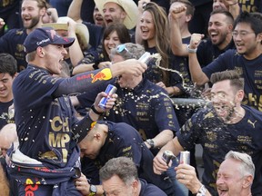 Red Bull driver Max Verstappen, of the Netherlands, celebrates with the Red Bull team following the Formula One U.S. Grand Prix auto race at Circuit of the Americas, Sunday, Oct. 23, 2022, in Austin, Texas. Verstappen won the race and team Red Bull won the constructors' championship.