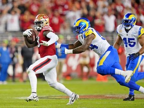 San Francisco 49ers wide receiver Deebo Samuel, left, runs with the ball as Los Angeles Rams linebacker Leonard Floyd pursues during the fourth quarter at Levi's Stadium in Santa Clara, Calif., Oct. 3, 2022.