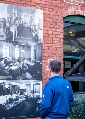 A visitor taking in some of the art exhibit celebrating the Distillery District’s history