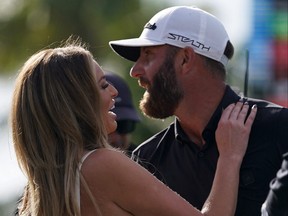 4Aces GC captain Dustin Johnson embraces his wife Paulina Gretzky after winning the team championship in the season finale of the LIV Golf series at Trump National Doral in Miami, Fla., Oct. 30, 2022.