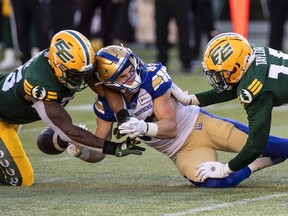 Winnipeg Blue Bombers Dalton Schoen (83) is tackled by Edmonton Elks Nyles Morgan (45) and Jeawon Taylor (16) during first half CFL action in Edmonton, Alta., on Friday July 22, 2022. .