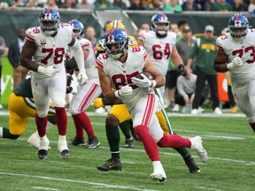 Oct 9, 2022; London, United Kingdom; New York Giants fullback Chris Myarick (85) carries the ball against the Green Bay Packers in the fourth quarter during an NFL International Series game at Tottenham Hotspur Stadium.