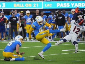 Oct 17, 2022; Inglewood, California, USA; Los Angeles Chargers place kicker Dustin Hopkins (6) kicks a 39-yard fielg goal out of the hold of punter JK Scott (16) in overtime against the Denver Broncos at SoFi Stadium.