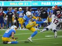 Oct 17, 2022; Inglewood, California, USA; Los Angeles Chargers place kicker Dustin Hopkins (6) kicks a 39-yard fielg goal out of the hold of punter JK Scott (16) in overtime against the Denver Broncos at SoFi Stadium. 