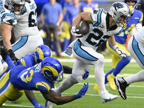 Oct 16, 2022; Inglewood, California, USA; Carolina Panthers running back Christian McCaffrey (22) tries to break a tackle by Los Angeles Rams linebacker Ernest Jones (53) during the fourth quarter at SoFi Stadium.