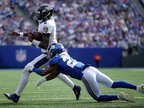 Oct 16, 2022; East Rutherford, New Jersey, USA; Baltimore Ravens quarterback Lamar Jackson (8) runs with the ball against New York Giants cornerback Adoree' Jackson (22) during the third quarter at MetLife Stadium.