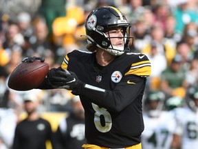 Oct 2, 2022; Pittsburgh, Pennsylvania, USA; Pittsburgh Steelers quarterback Kenny Pickett (8) looks for a receiver against the New York Jets during the fourth quarter at Acrisure Stadium. The Jets won 24-20.