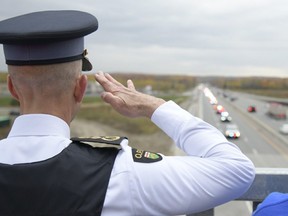 OPP salute the procession for Constable Morgan Russell and Constable Devon Northrup on Hwy. 400 on Friday, Oct. 14, 2022.