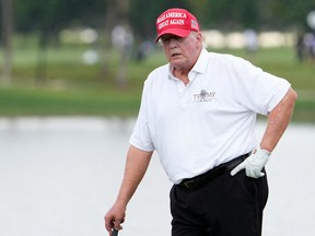 Former President Donald Trump stands on the 18th green during the Pro-Am tournament before the LIV Golf series at Trump National Doral in Miami Oct. 27, 2022.