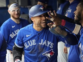 Blue Jays centre fielder George Springer (centre) celebrates scoring against the Red Sox during the fifth inning at Rogers Centre in Toronto, Saturday, Oct. 1, 2022.