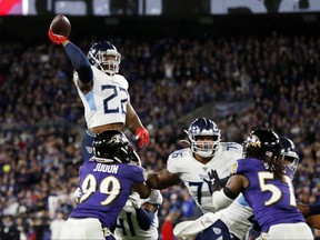 Derrick Henry of the Tennessee Titans throws a touchdown pass to Corey Davis in the third quarter of the AFC Divisional Playoff game against the Baltimore Ravens at M&T Bank Stadium on January 11, 2020 in Baltimore, Maryland.