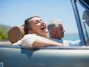 Mature couple driving in convertible