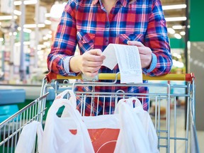 Checking the bill after grocery shopping.