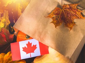 Happy Thanksgiving Day in Canada. Vegetables, pumpkins, squash, apples, maple and oak leaves, acorns on a wooden background. Harvest and yellow autumn leaves on a wooden table.