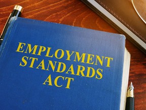 Employment standards act and glasses on a desk.