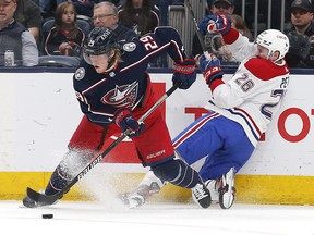 Apr 13, 2022; Columbus, Ohio, USA; Columbus Blue Jackets right wing Patrik Laine (29) passes the puck after colliding with Montreal Canadiens defenseman Jeff Petry (26) during the second period at Nationwide Arena.