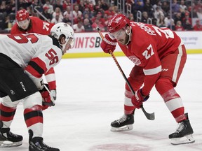 Michael Rasmussen of the Detroit Red Wings and faces off against Erik Haula of the New Jersey Devils during the second period of the game at Little Caesars Arena in Detroit, Oct. 25, 2022.