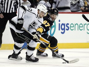 Los Angeles Kings left wing Kevin Fiala (22) moves the puck against Pittsburgh Penguins center Sidney Crosby (87) during the first period at PPG Paints Arena.