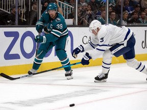 Maple Leafs defenceman Justin Holl lunges after Sharks’ Logan Couture during the second period of their game at the SAP Center in San Jose on Thursday night. Holl had another rough game and was given some “direct honest feedback” from head coach Sheldon Keefe at practice in Los Angeles yesterday.