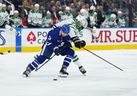 Maple Leafs' Justin Holl (left) battles for the puck with Dallas Stars' Mason Marchment during the second period at Scotiabank Arena on Thursday, Oct. 20, 2022. 