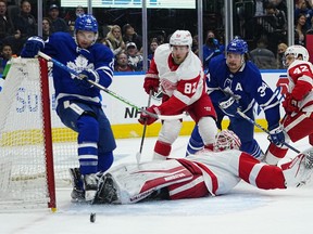 Alex Kerfoot (left) and Auston Matthews, here storming the Red Wings crease during a pre-season game, will be back on the same line, along with Mitch Marner, tonight in San Jose.