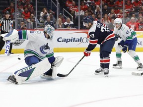 Oct 17, 2022; Washington, District of Columbia, USA; Washington Capitals left wing Conor Sheary (73) scores a goal on Vancouver Canucks goaltender Thatcher Demko (35) in the third period at Capital One Arena.