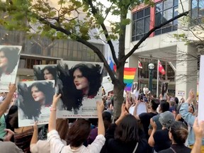 People attend a protest in solidarity with the women in Iran, following the death of Mahsa Amini, in Toronto, Sept. 19, 2022 in this screen grab obtained from social media video obtained by Reuters.