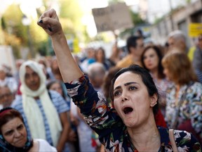 A woman gestures during a protest against the Islamic regime of Iran and the death of Mahsa Amini in front of the Iranian Embassy in Madrid, Oct. 6, 2022.