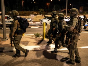 Israeli soldiers patrol the area following a shooting incident at a check point in East Jerusalem, Israeli police said October 8, 2022.