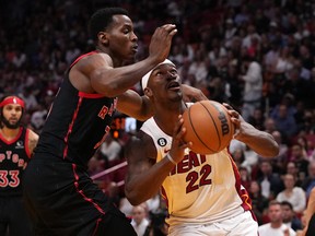 Miami Heat forward Jimmy Butler (22) drives the ball around Toronto Raptors forward Christian Koloko  on Monday night.