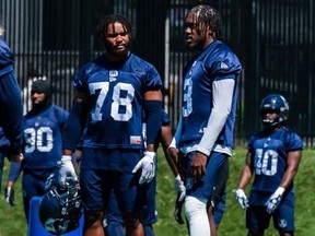 Jonathan Jones (right) chatting with a teammate at practice, makes his second start at linebacker for the Argos on Saturday in Edmonton.