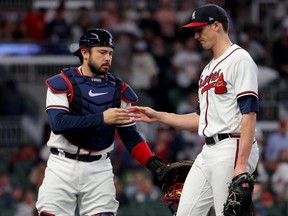 Braves catcher Travis d'Arnaud, left, and pitcher Kyle Wright, right, react after a strike out against the Phillies during the third inning in Game 2 of the National League Division Series at Truist Park in Atlanta, Wednesday, Oct. 12, 2022.
