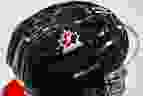 A Hockey Canada logo is visible on the helmet of a national junior team player.