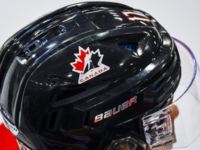 A Hockey Canada logo is visible on the helmet of a national junior team player.