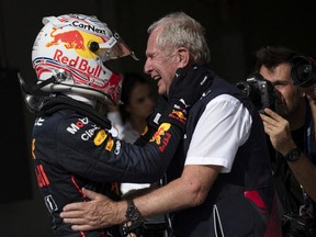 Red Bull's Max Verstappen celebrates after winning the United States Grand Prix with Red Bull advisor Helmut Marko.